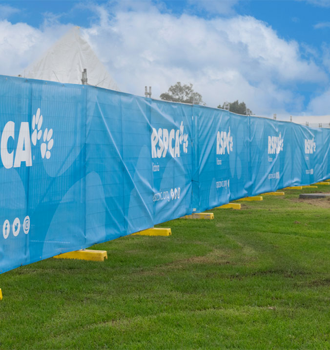 Mesh banners on temporary fence at an event